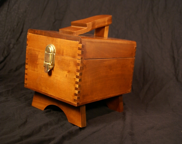 Stained hinged top custom wood shoe shine kit with brass front clasp and platform on to to hold shoe in place.